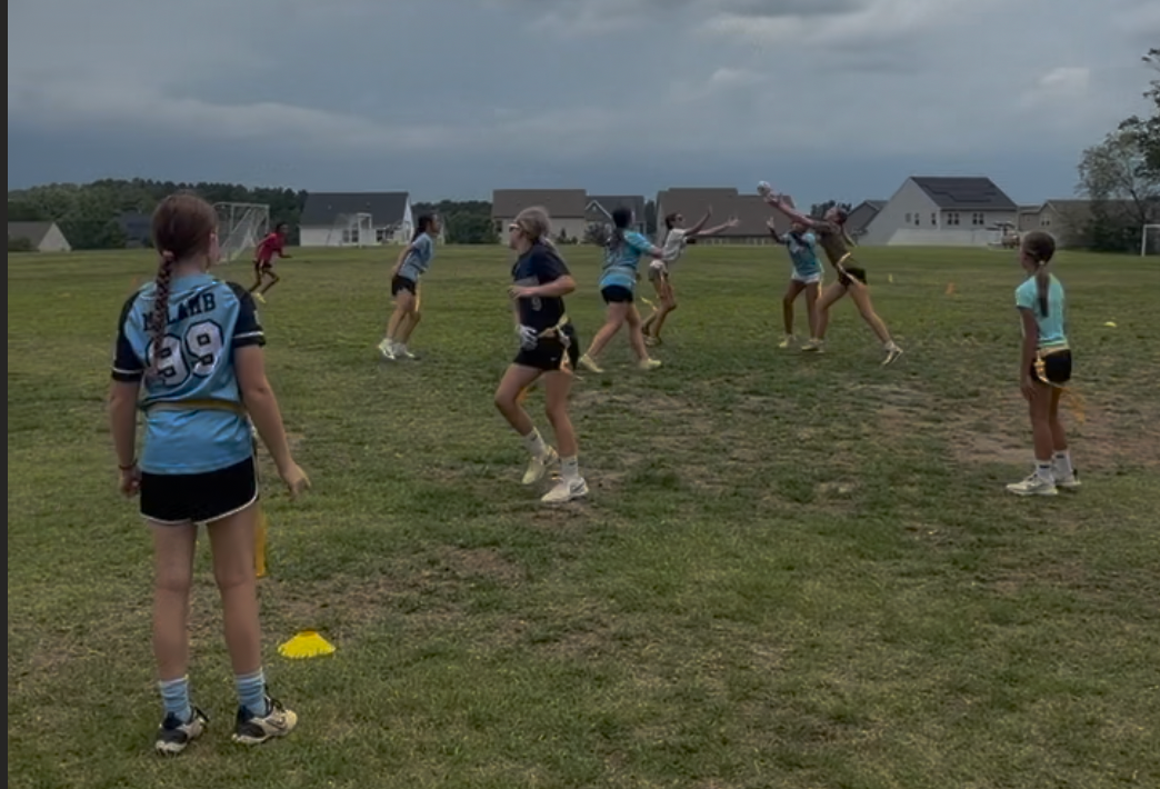 Girls flag football athletes training on the field